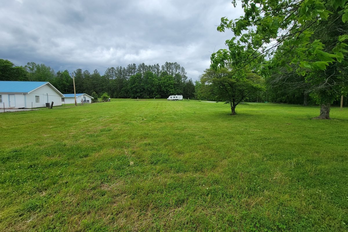 The same ground mowed down, open toward the treeline