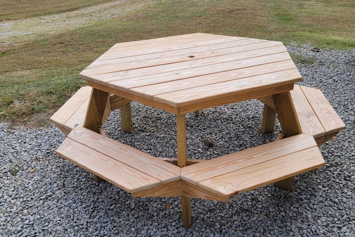 A new hexagonal picnic table standing on the gravel pad