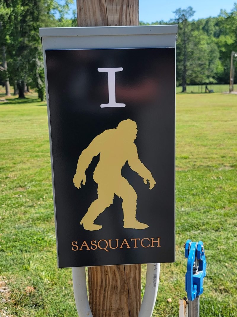 Site 1 pedestal panel, a gold Sasquatch figure on black above the name Sasquatch