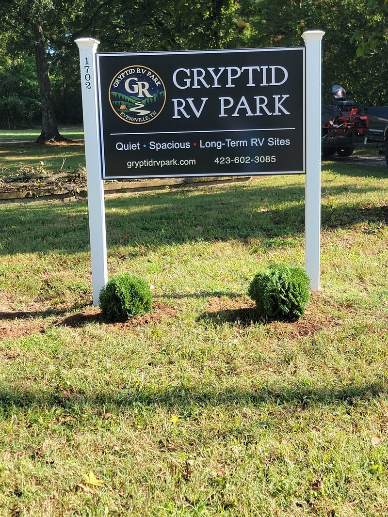 The Gryptid RV Park entrance sign at the road, reading quiet, spacious, long term RV sites