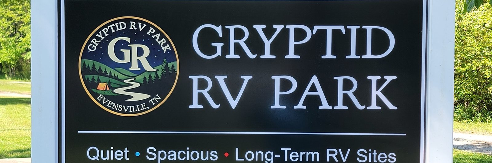 The Gryptid RV Park entrance sign reading Quiet, Spacious, Long-Term RV Sites